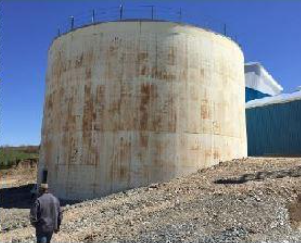 Large cylindrical tank at a farm energy project.