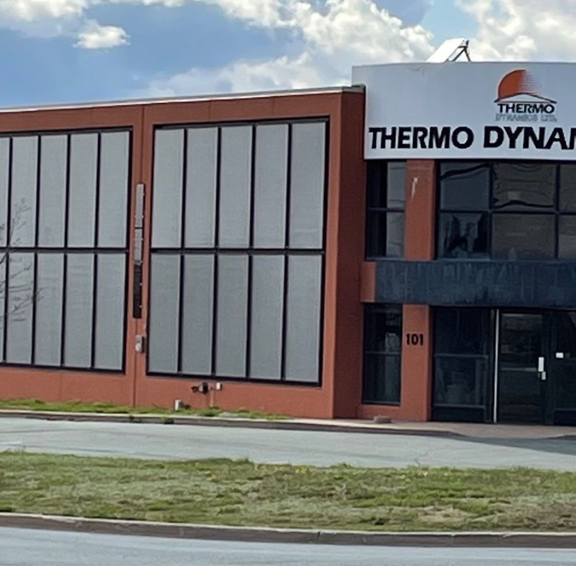 Thermo Dynamics building with solar collectors on its facade.