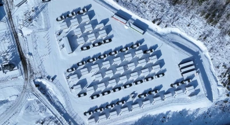 Aerial view of a grid battery storage installation surrounded by snow.