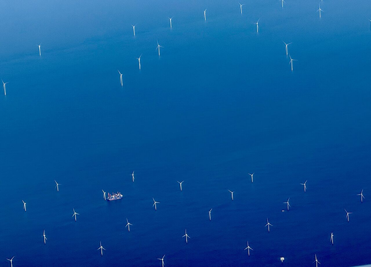 Offshore wind turbines photographed from an aircraft above the sea.