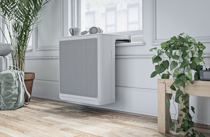 Compact window-mounted heat pump inside a room.