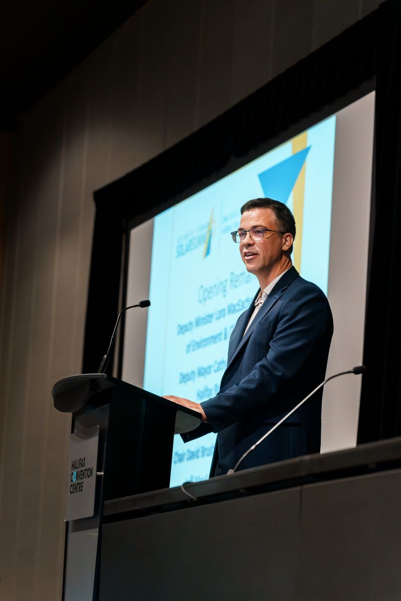 David Brushett speaking at a lectern at the Halifax Convention Centre.